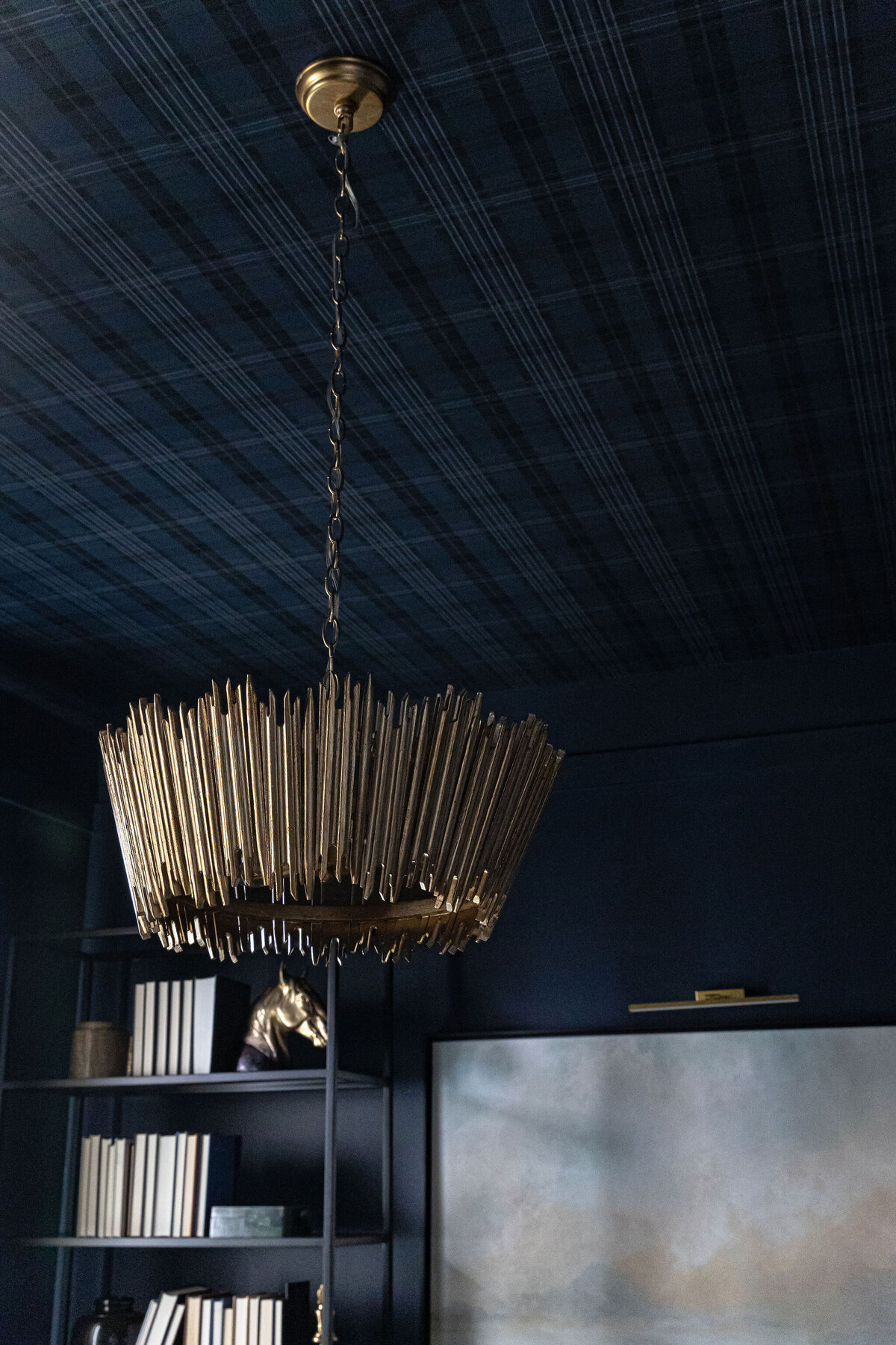 a gold chandelier with a geometric design
