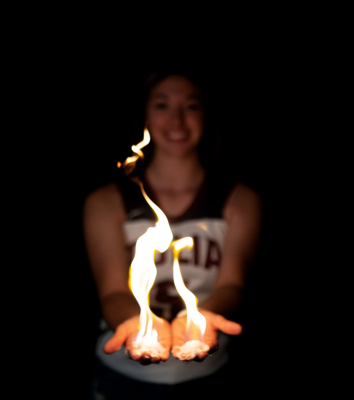 Tulia high school varsity basketball player holding fire in her hands