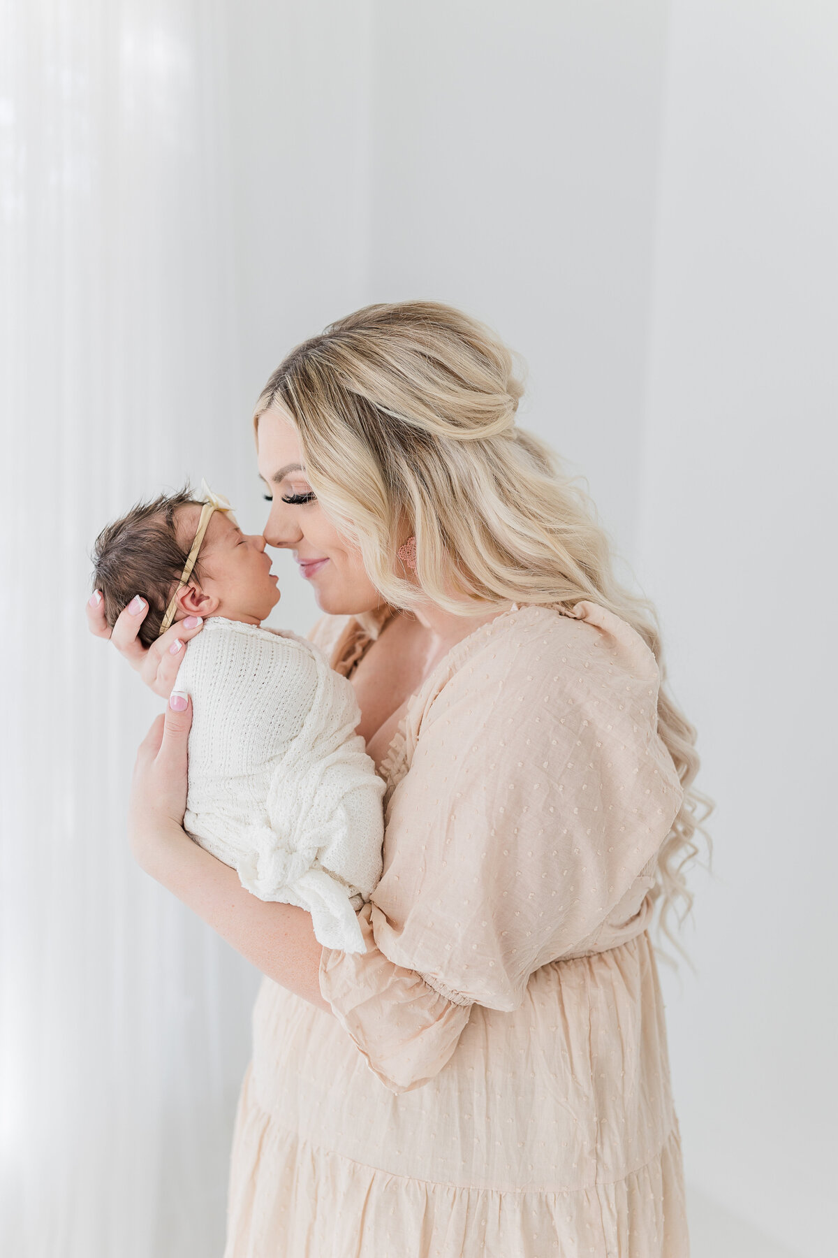 Folsom newborn photographer capturing mother holding newborn baby girl.