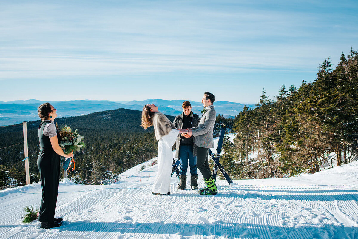 couple laughing during wedding ceremony at killington vermont elopement on skis in vermont