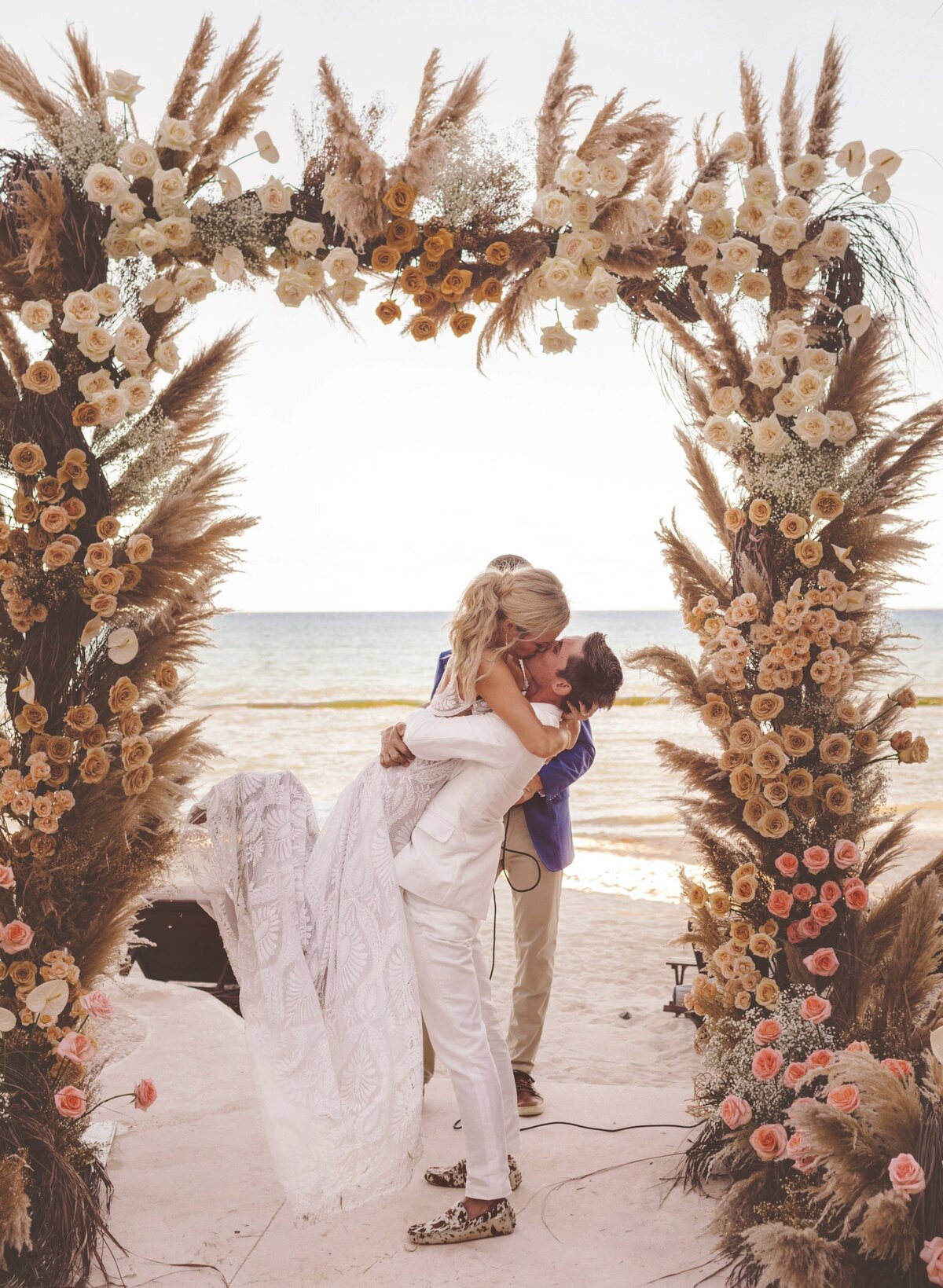 Bride and groom's first kiss at wedding in Riviera Maya