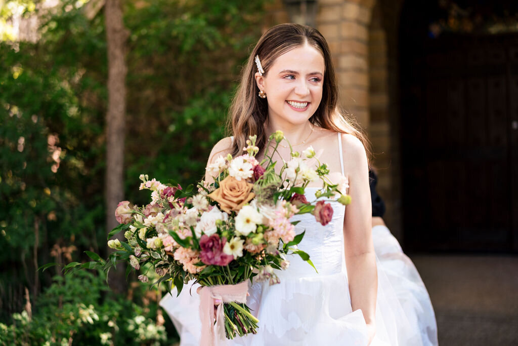 bride holding her romantic garden inspired bouquet
