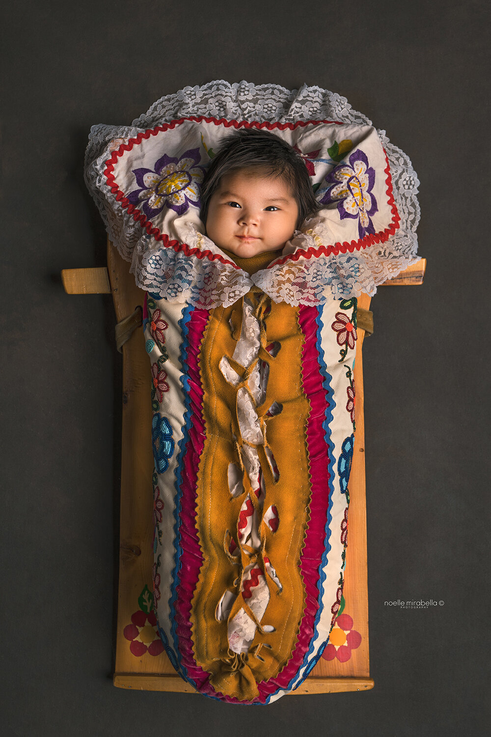 Metis' baby in cradle board, grande prairie newborn photographer