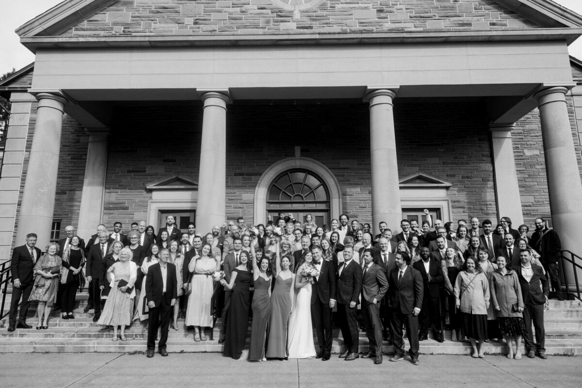 Bride and groom outside church in Halifax, Nova Scotia with all their wedding guests