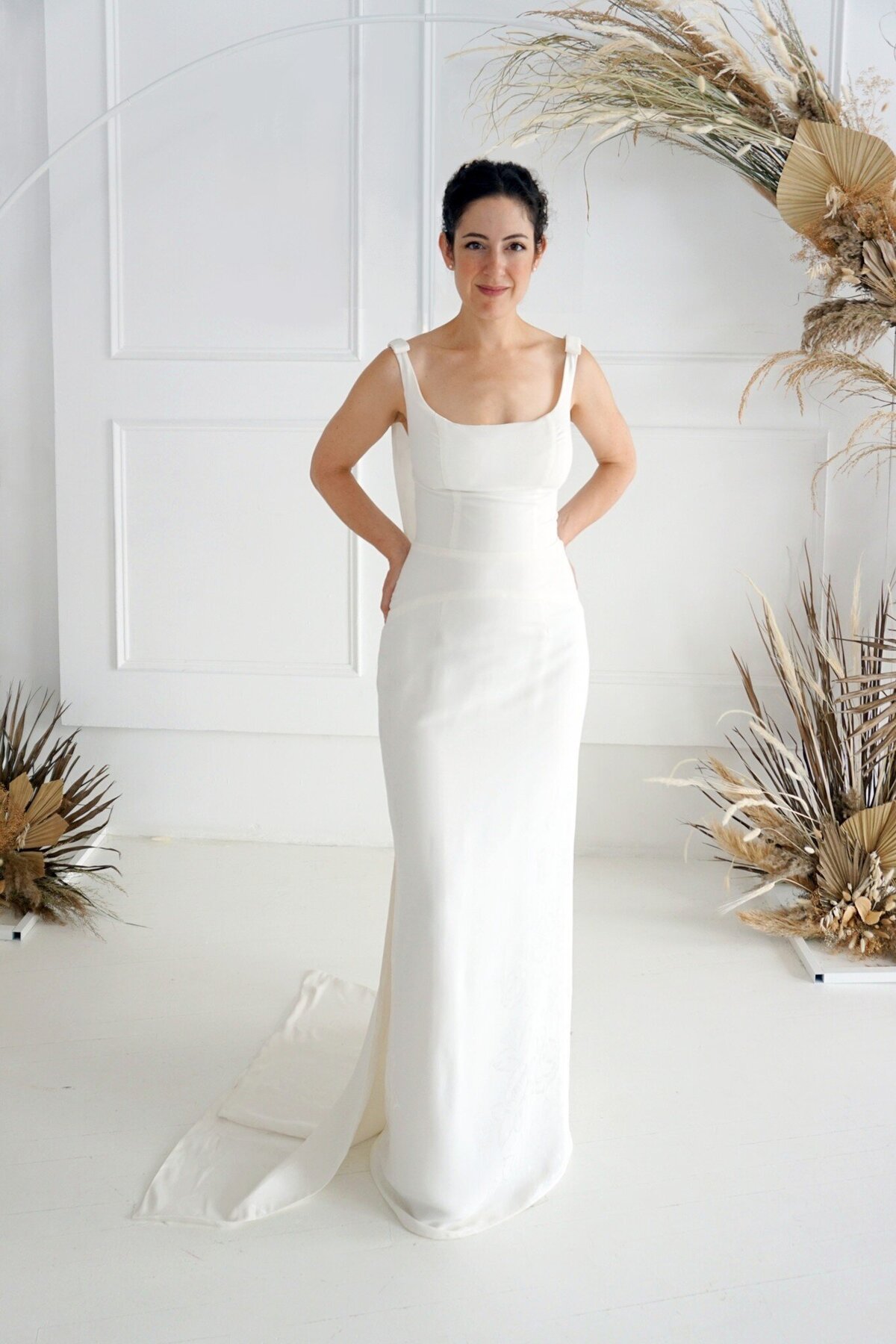 Front view of the Jealine style highlighting the unique seamlines and rounded square neckline of the floral crepe wedding gown.