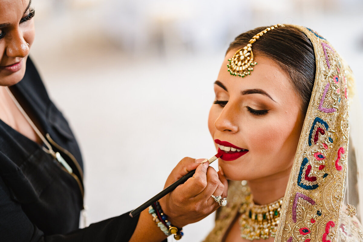 bride having makeup applied at stapleford park hotel