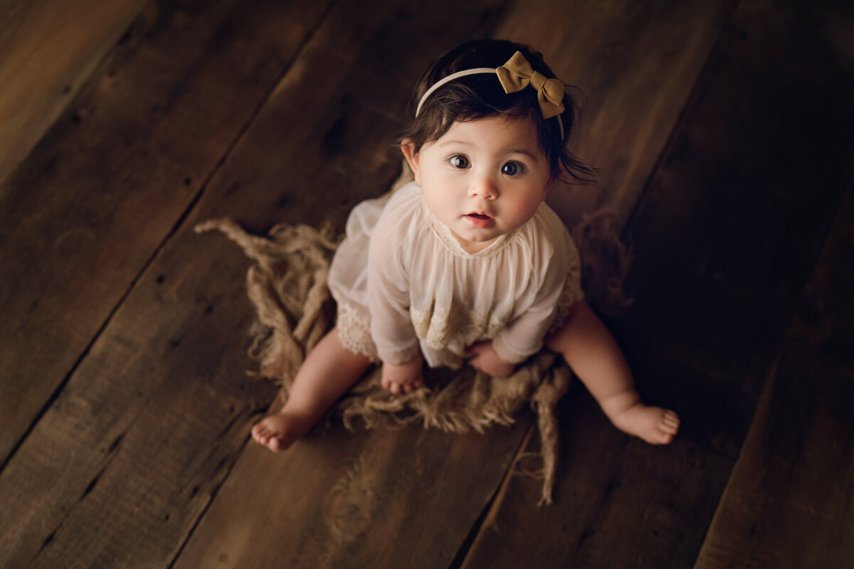 baby girl on wooden background