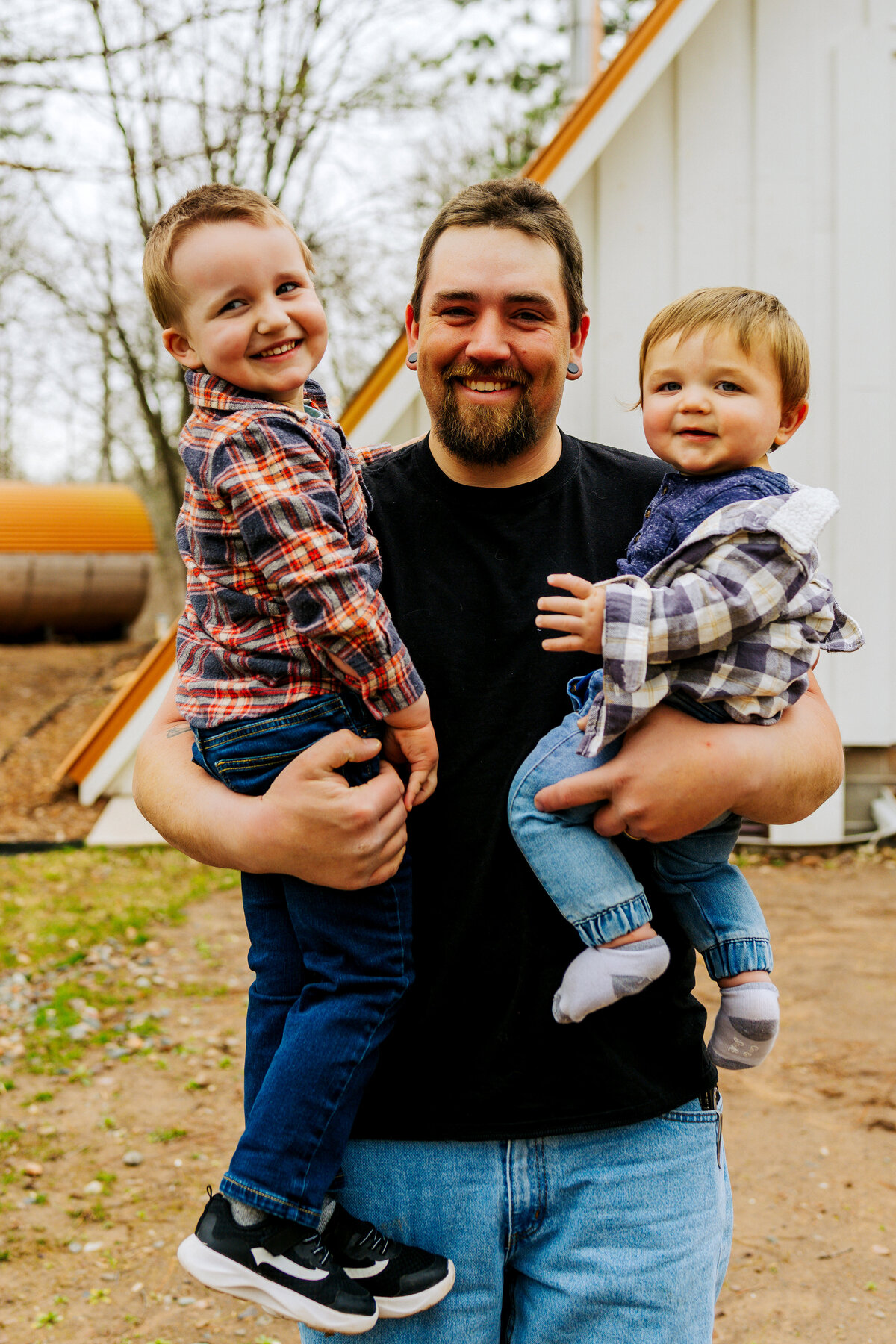 father with two kids smiling at camera