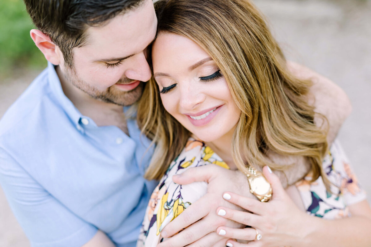 Couple holding hands and embracing at their Austin engagement session