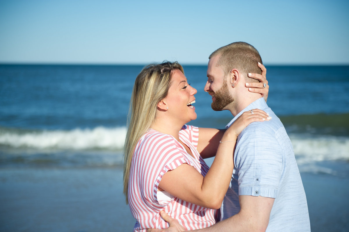 suprise proposal with couple smiling on beach