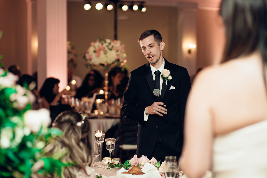 Wedding Photograph Of Groom In Black Suit Holding a Microphone  Los Angeles