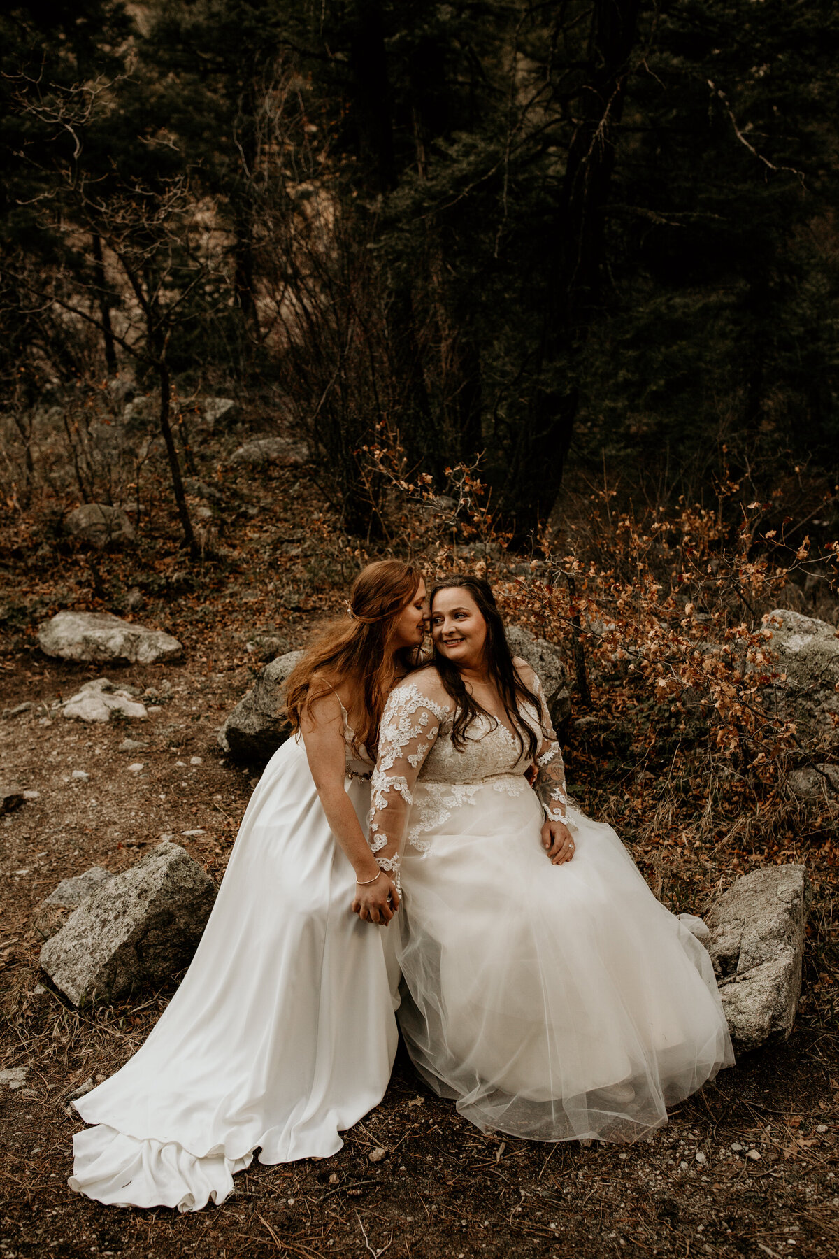 two brides sitting together after elopement ceremony