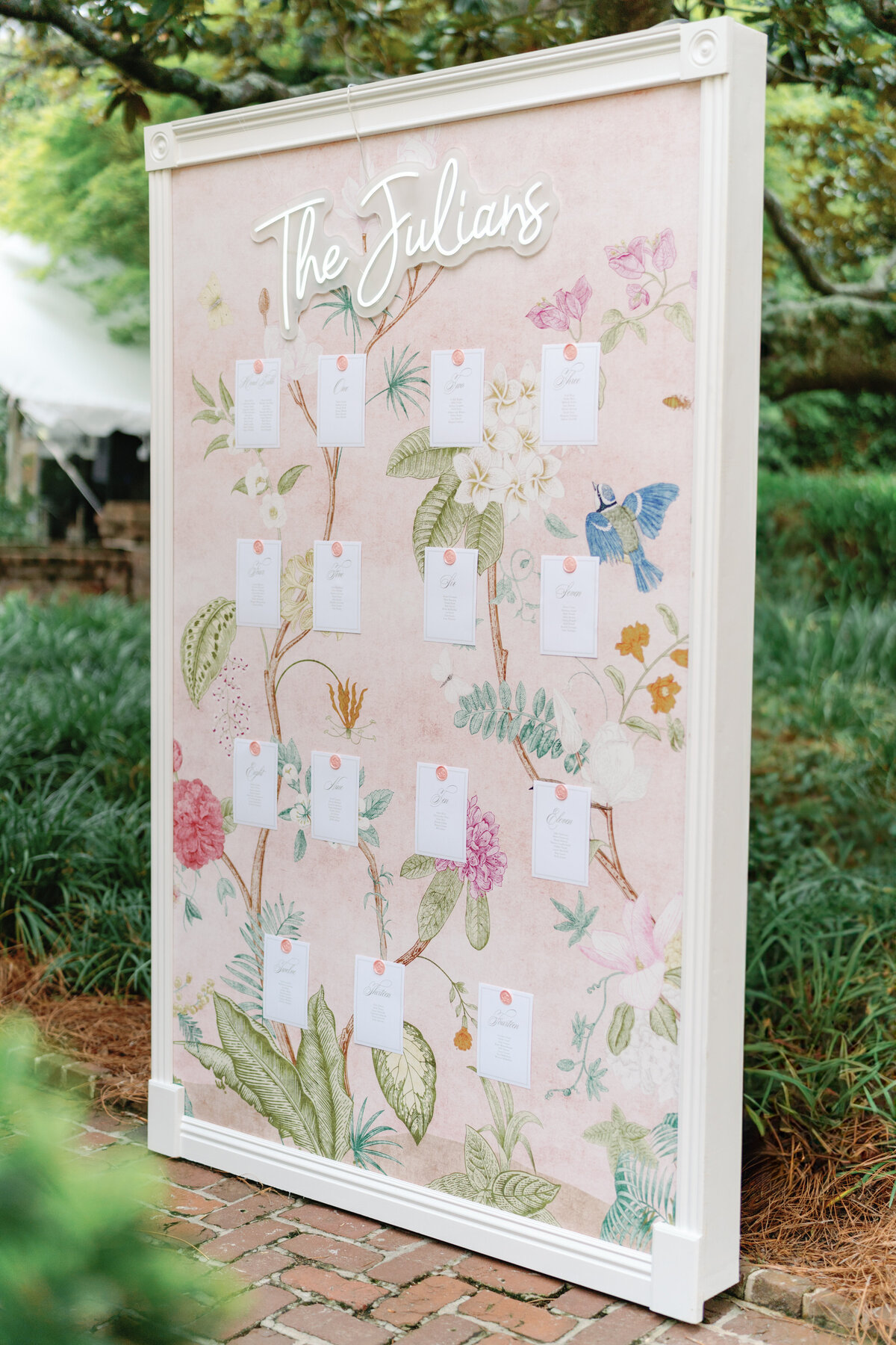 Pink wildflower wall paper seating chart at gorgeous spring wedding at William Aiken House. Charleston destination wedding photographer.