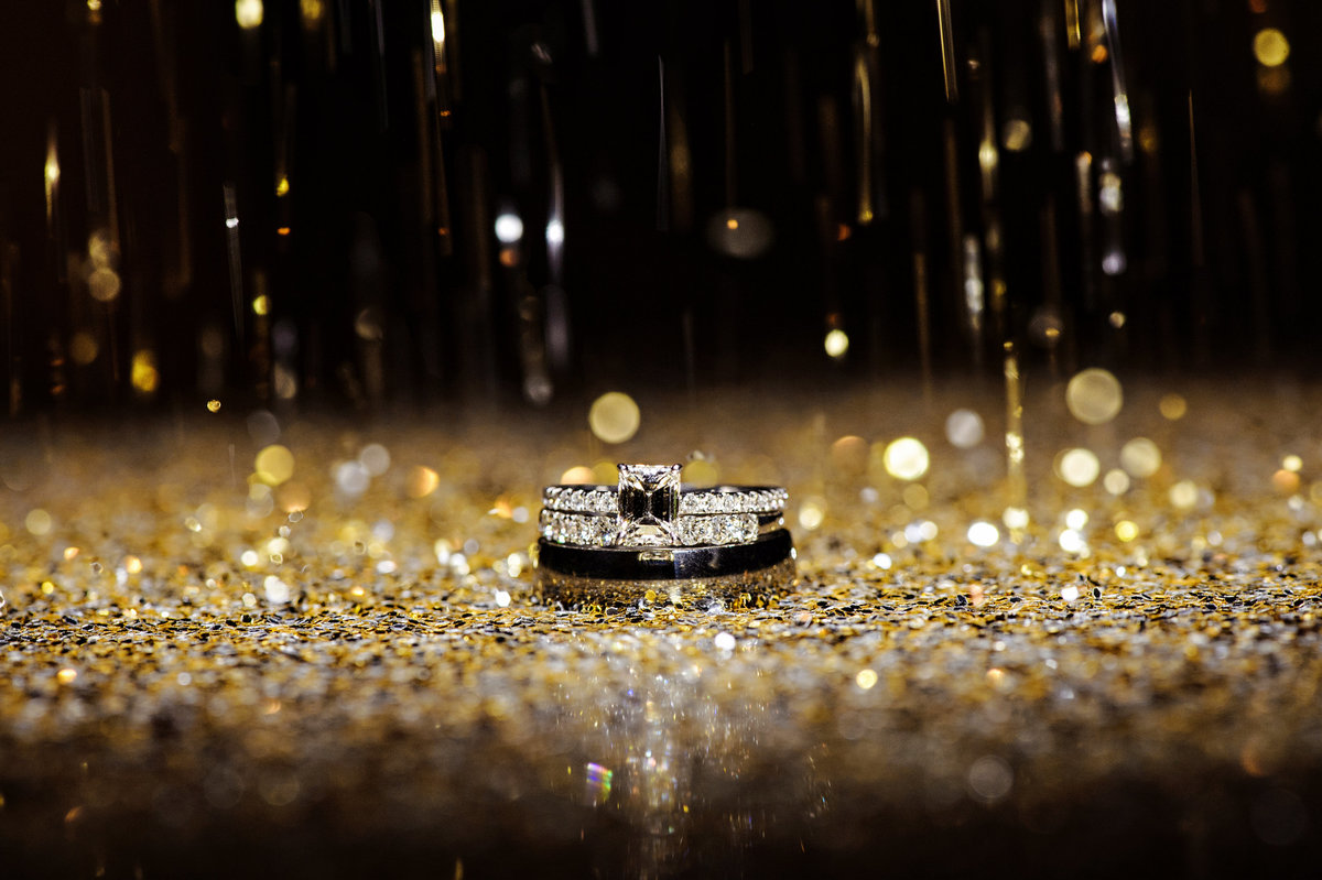Wedding rings sprinkled with gold glitter at the Chelsea Hotel Wedding.