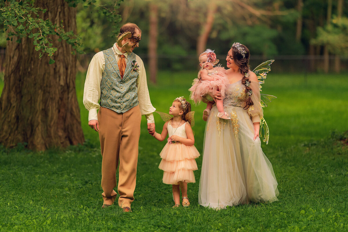 Mom and Dad bring their two daughters outside for a magical fairy-themed portrait session straight out of a storybook.