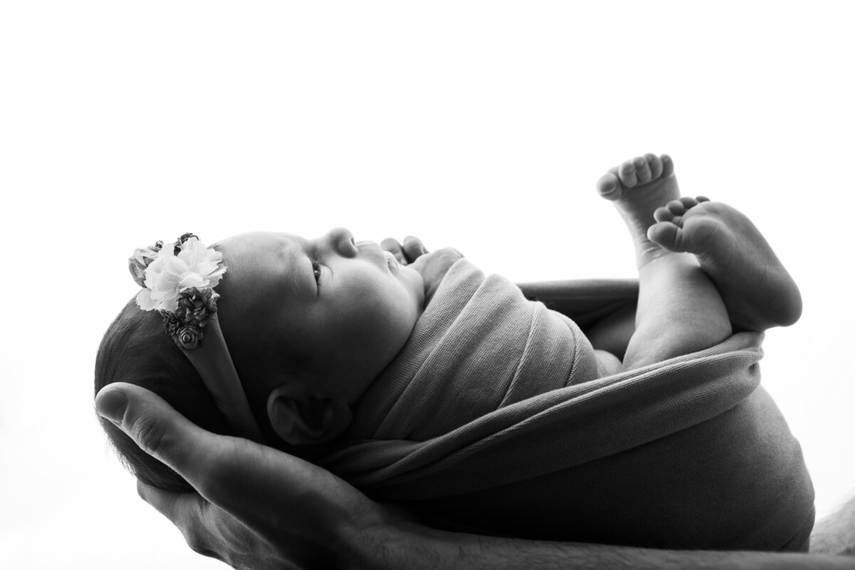 Black and white silhouette newborn pose