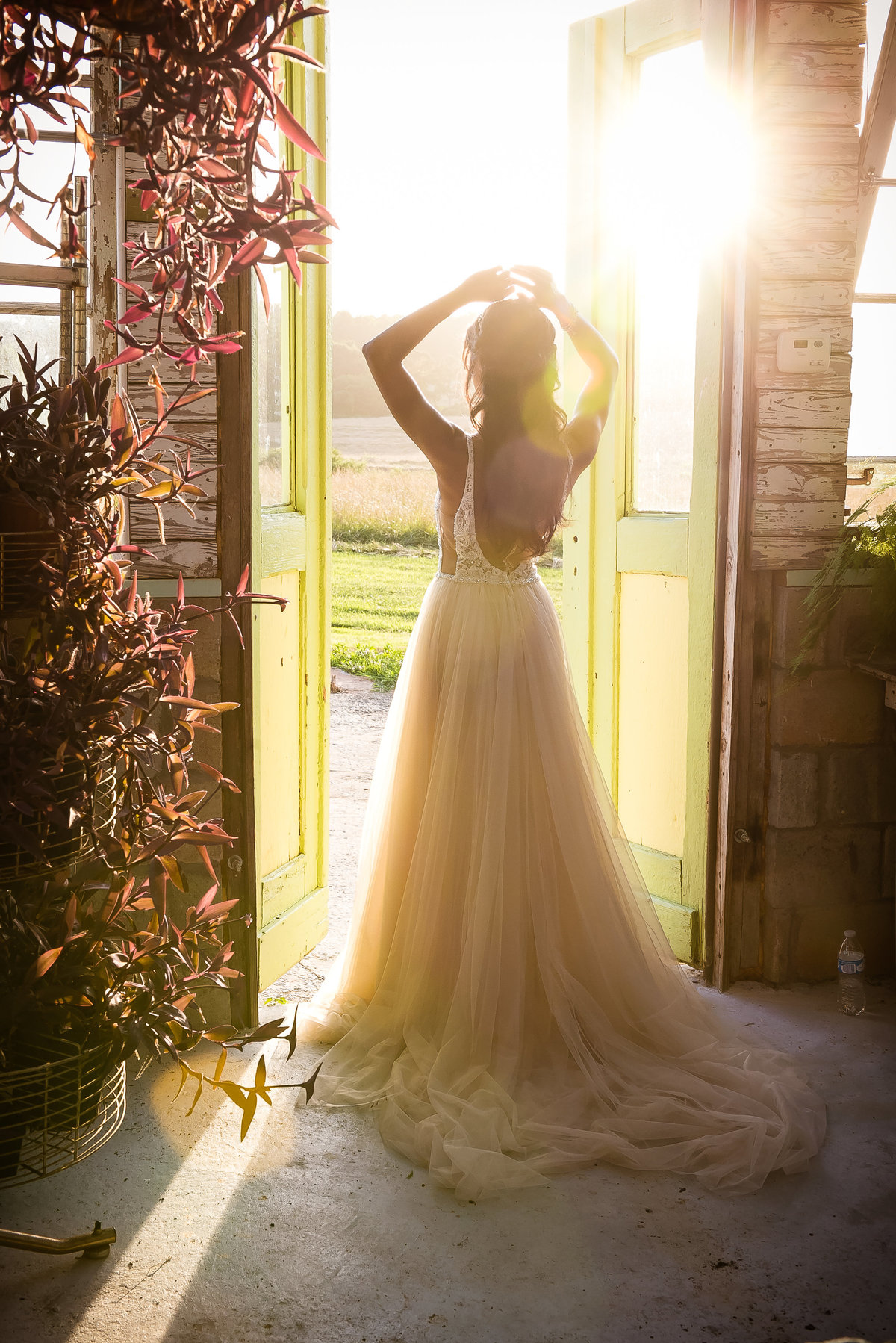 Bride in doorway at sunset