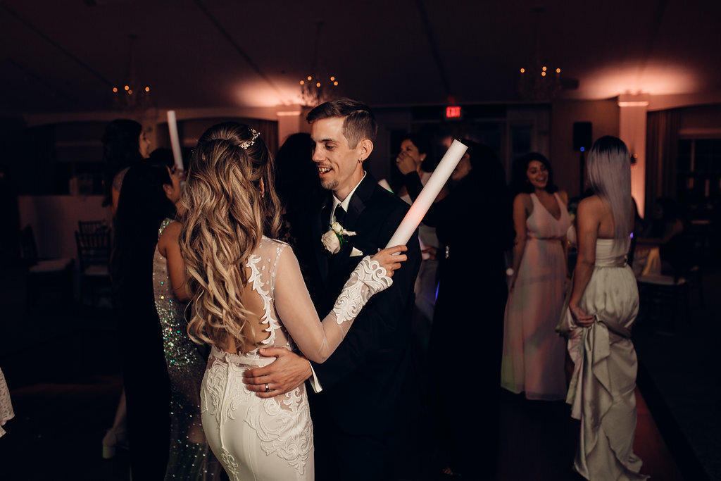 Wedding Photograph Of Bride Raising Her Light Stick While Dancing With The Groom Los Angeles