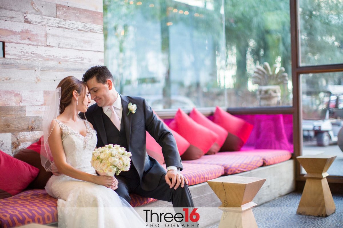 Bride and Groom sitting on a couch enjoying the moment together