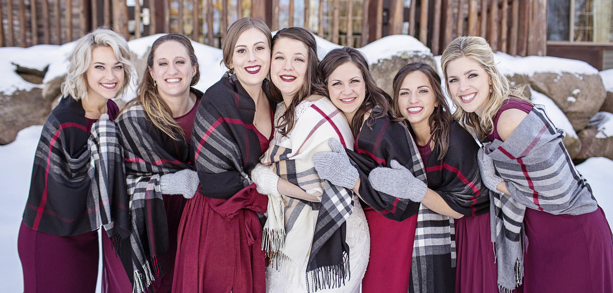 Bridesmaids in winter wedding in Minnesota and Wisconsin wearing deep red. bridesmaids in scarfs.