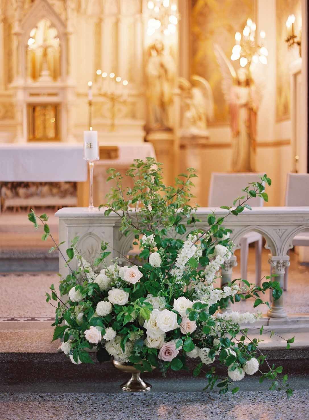large greenery arrangement with white flowers at Villa Academy Chapel wedding in Seattle
