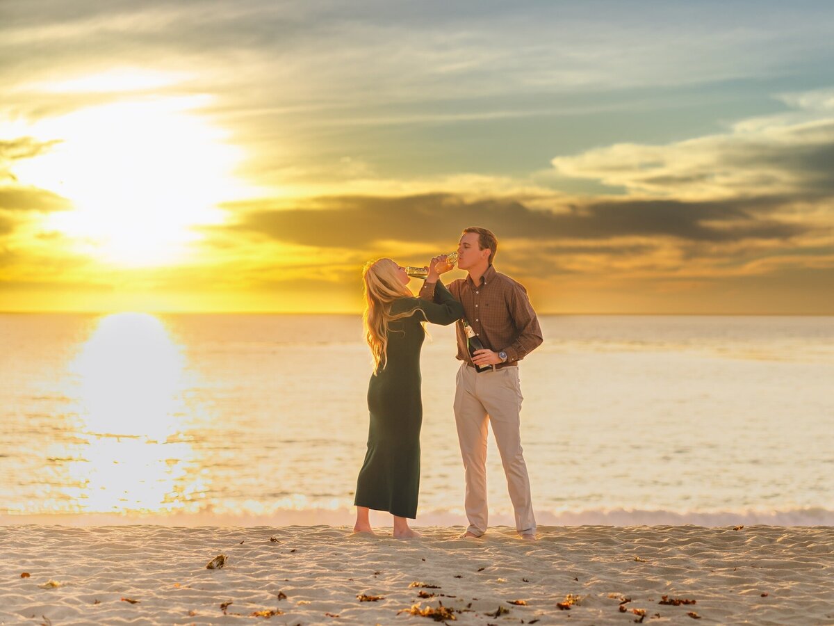 Engagement photography with champagne in Carmen Beach California. Photo by 4Karma Studio
