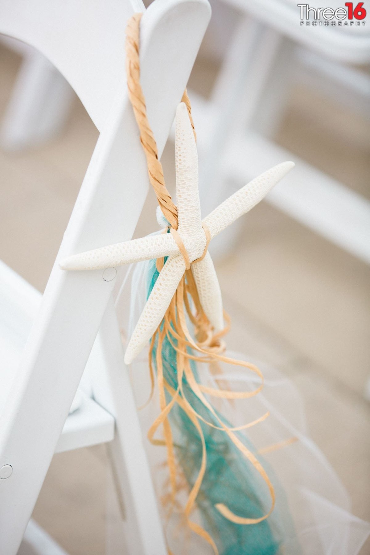 Beach themed decor on the chairs of a wedding ceremony at the Hotel Maya wedding venue