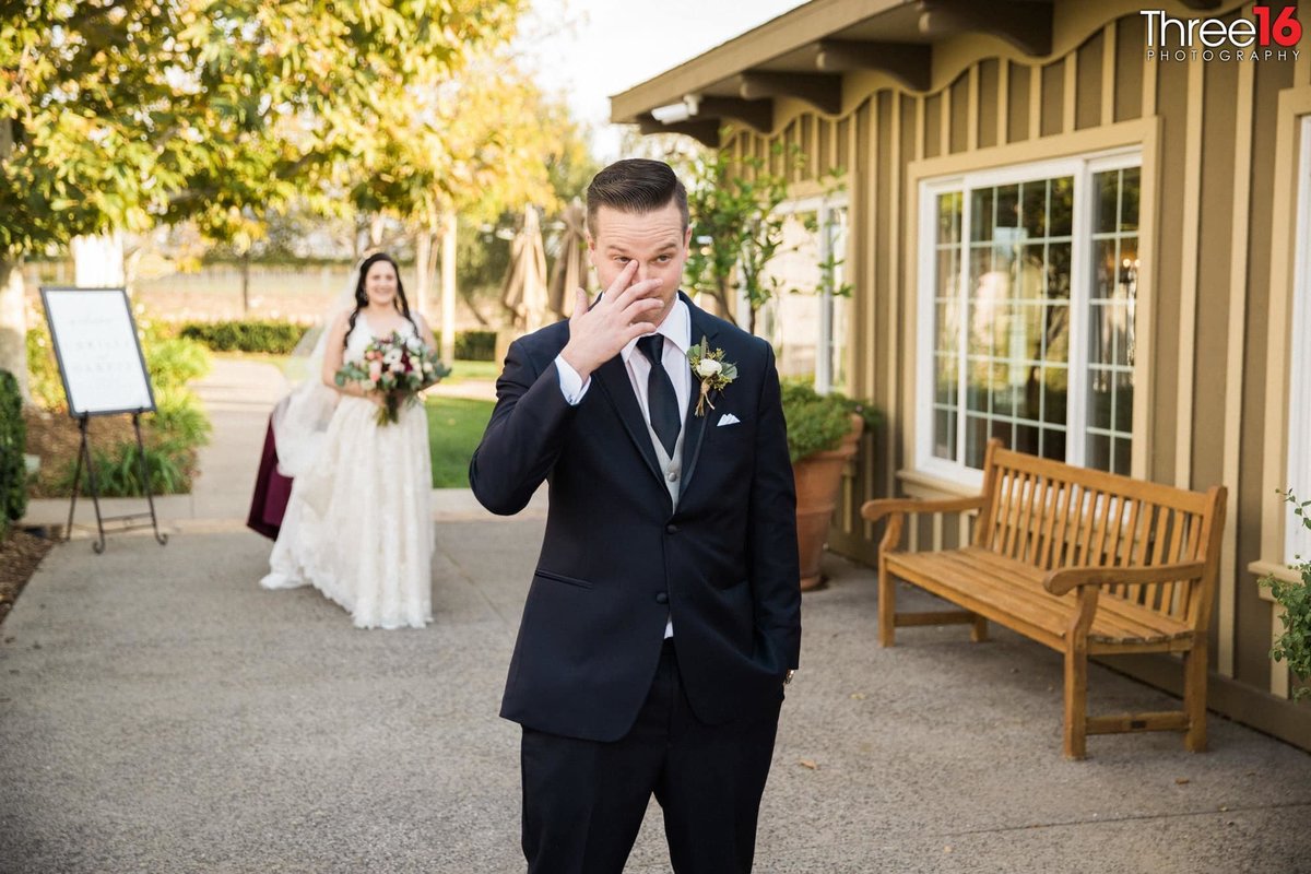 Teary-eyed Groom prior to his first look at his Bride in her wedding gown