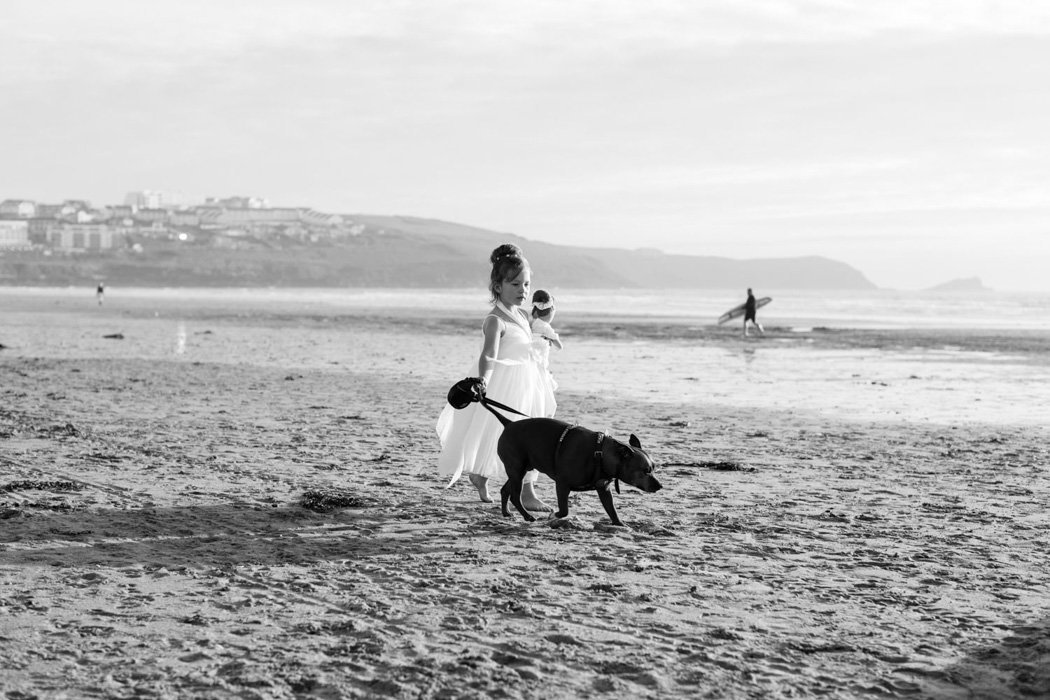 Flowergirl and her dog on the beach at Woolacombe Bay Hotel Wedding