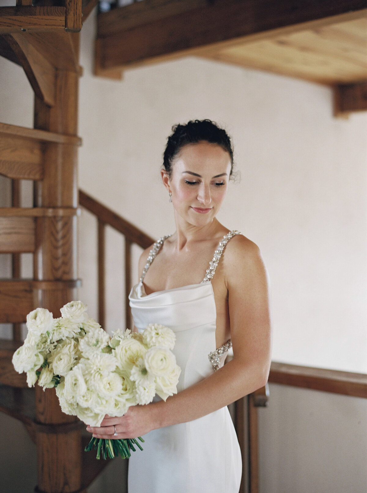 Lush white bridal bouquet with roses and ranunculus