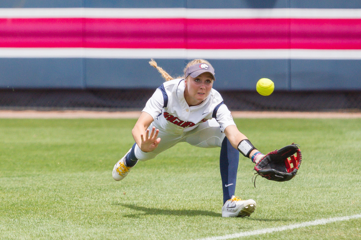 University of South Alabama softballer outfielder catches a fly ball for an out.