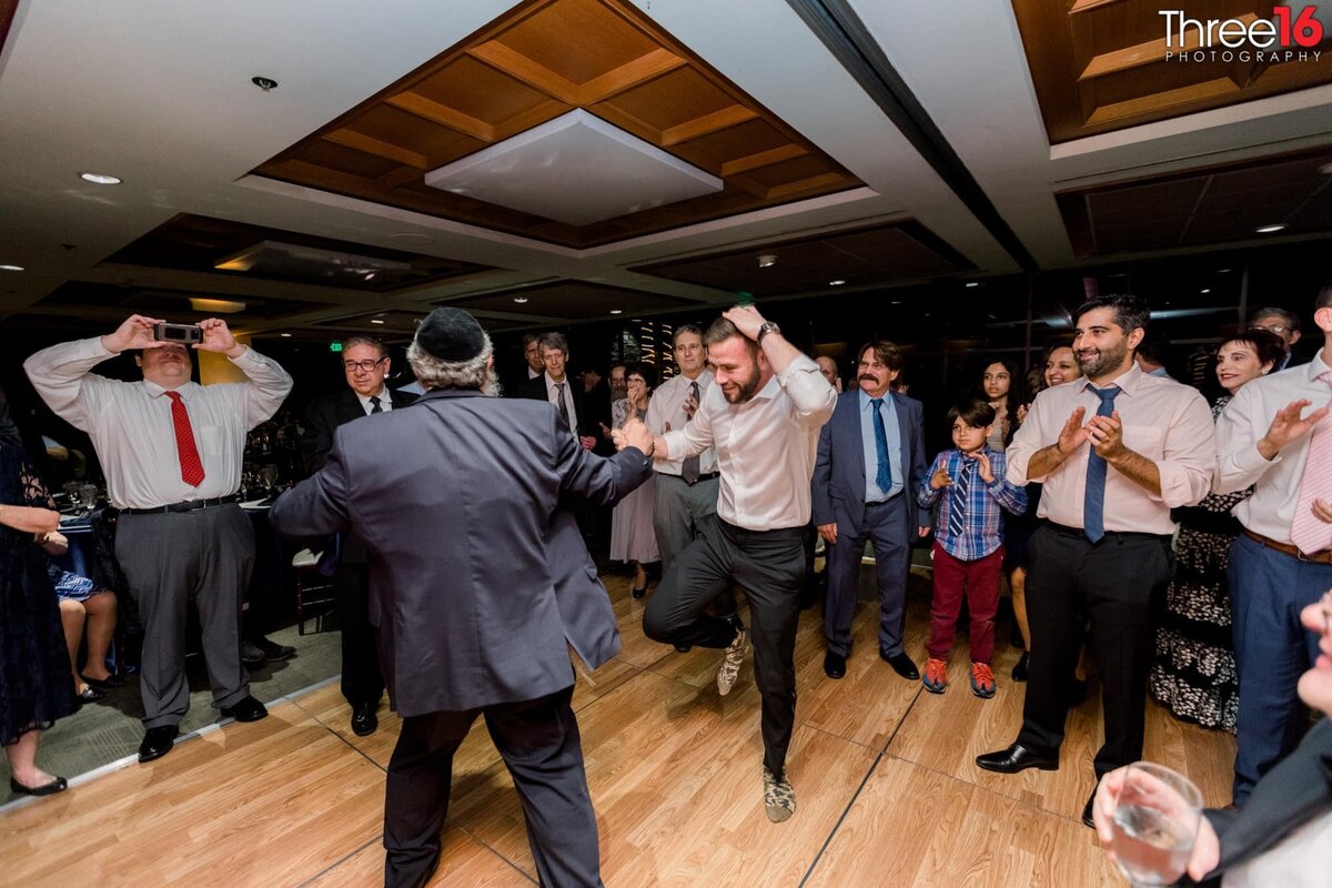 Men dancing at the wedding reception