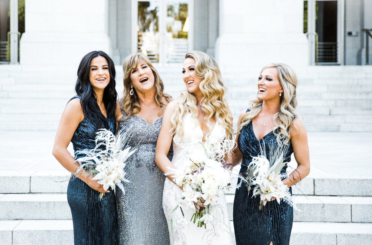 bride and bridesmaids with white bouquets