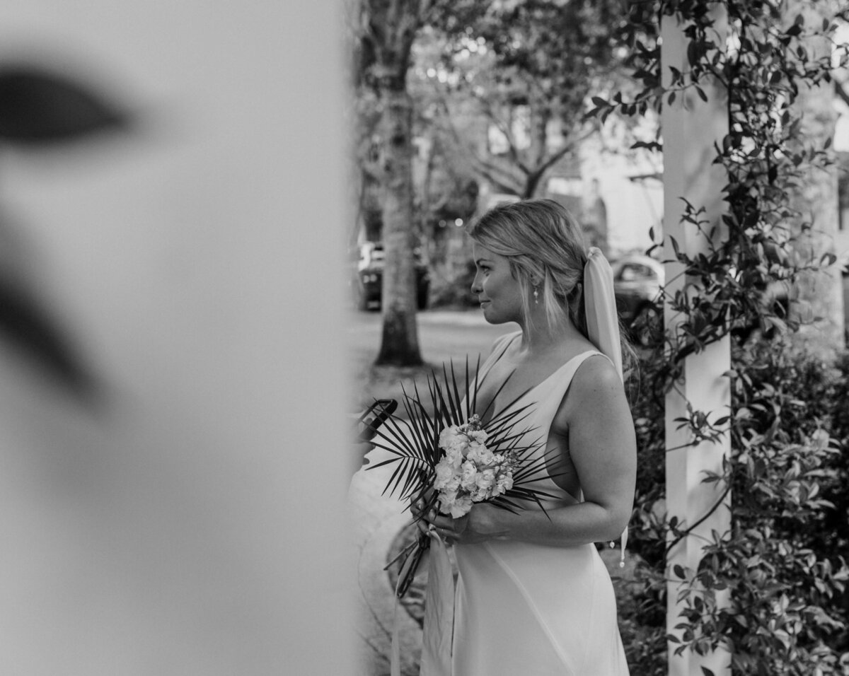 b&w shot of bride holding tropical bouquet during intimate wedding