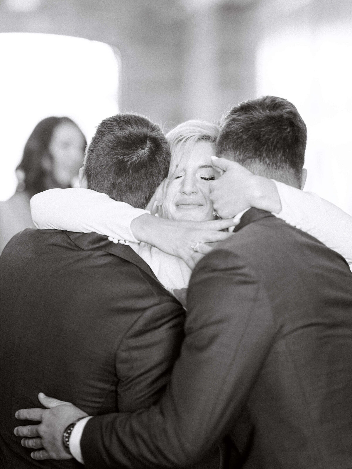 Intimate moment with Texan bride hugging her brothers before walking down the aisle