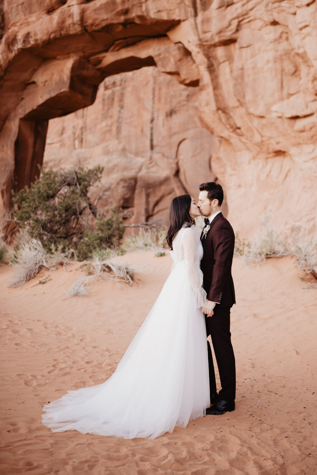 Utah elopement photographer captures couple kissing in Arches National Park