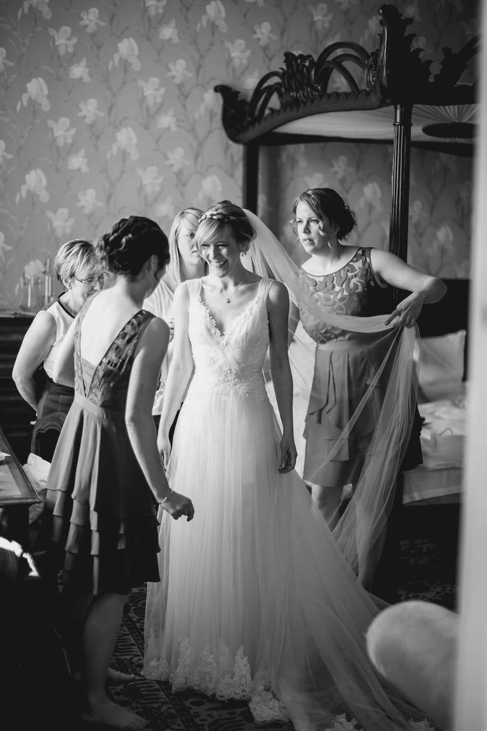 Bridesmaids helping Bride to get ready at Huntsham Court Devon