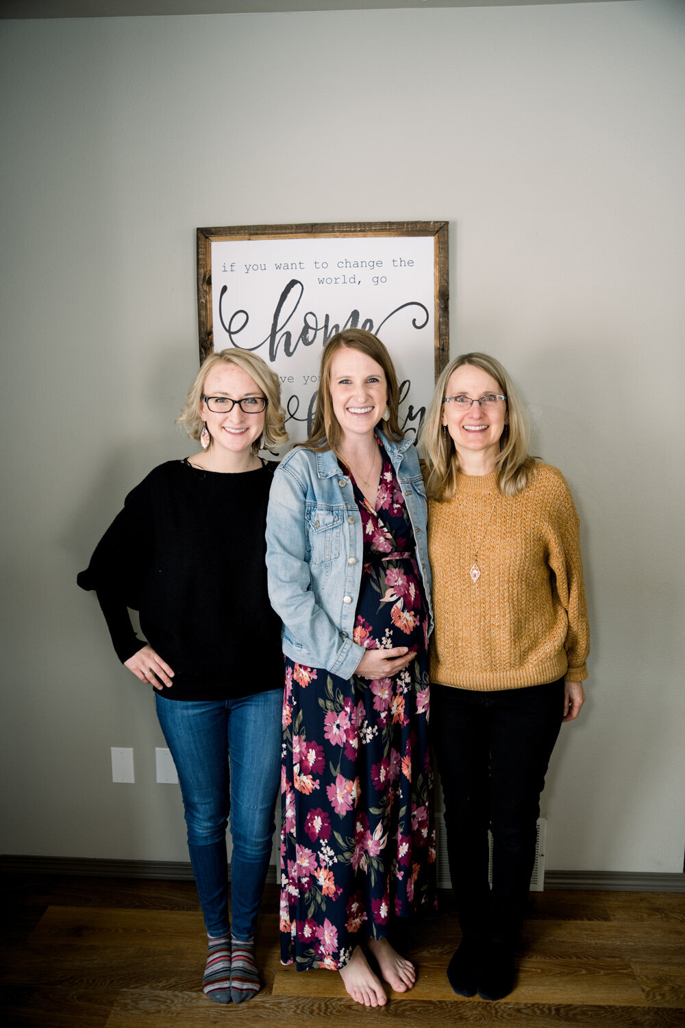Mom-to-be posing with her guests at a vibrant pink and yellow girl baby shower, showcasing joyful smiles and celebration.