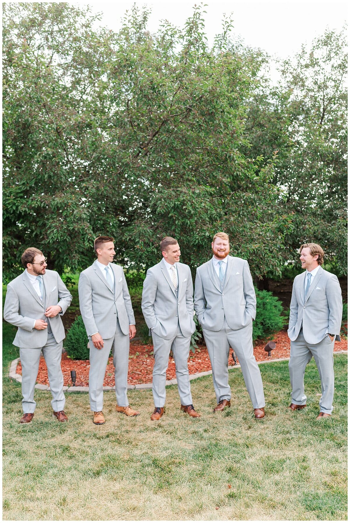 Four groomsmen stand around a groom before his ceremony at the chateaux at fox meadows