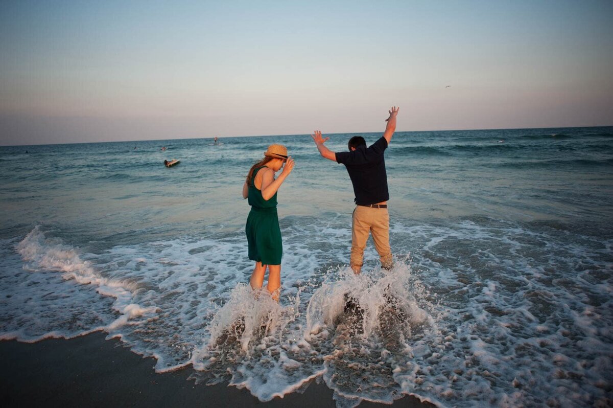 a rogue wave in the atlantic ocean gets a couple wet during their engagement photos