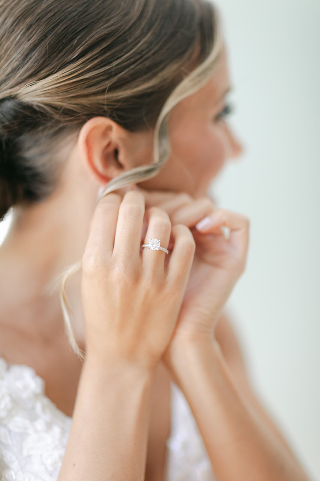 bride-putting-on-earrings