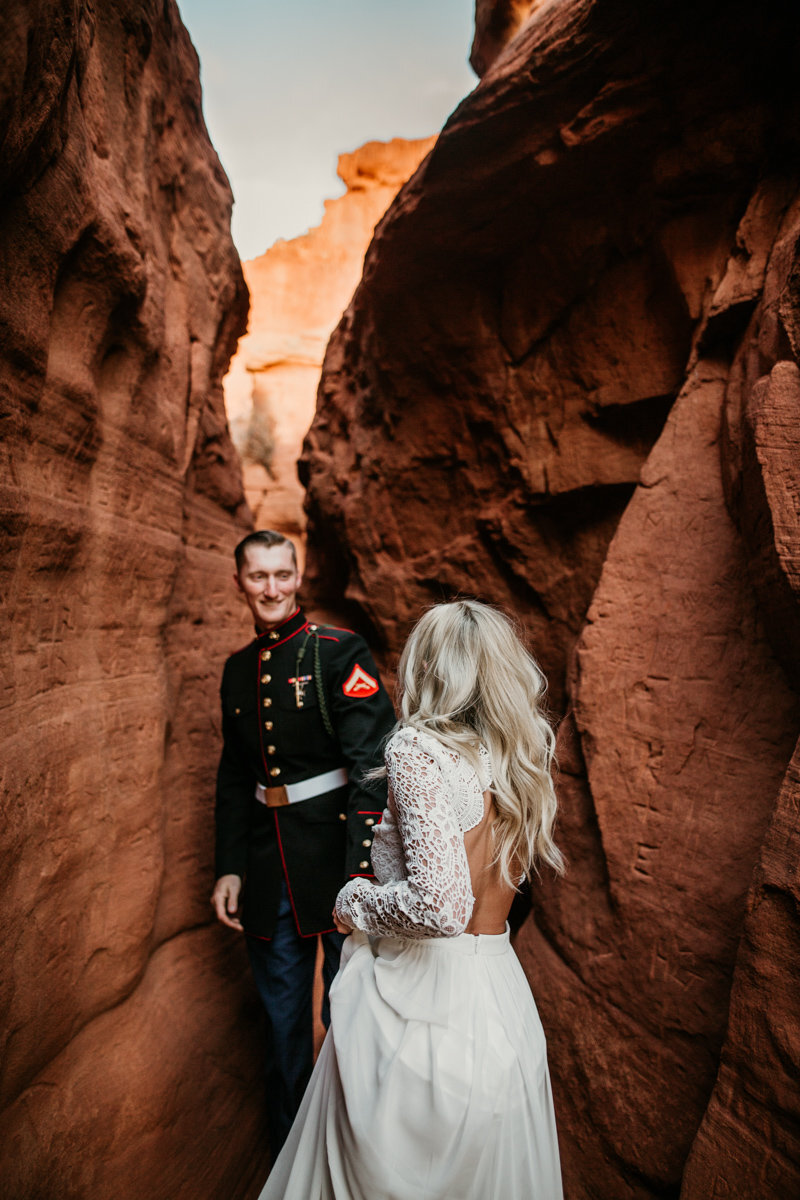 husband and wife walking through a New Mexico canyon