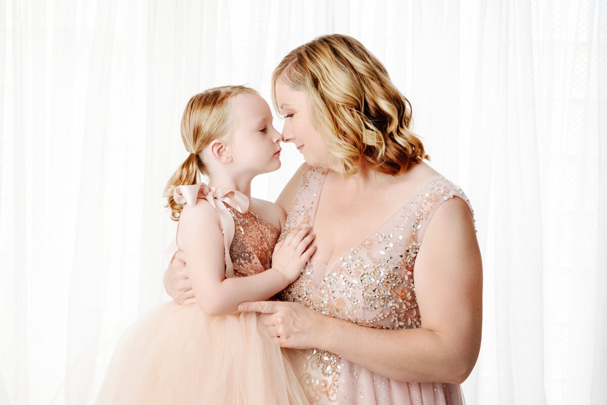 st-louis-motherhood-photographer-mom-and-daugher-in-pink-gowns-looking-at-each-other