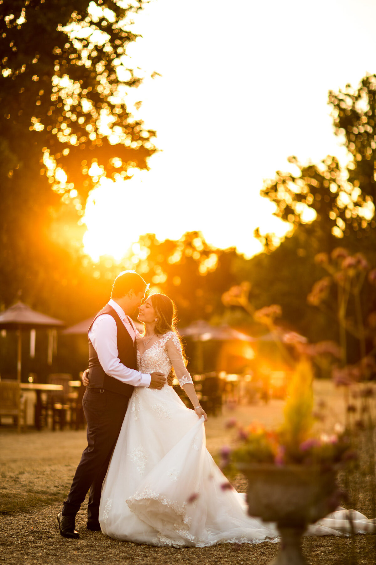 Bride with ballgown dress at sunset with groom