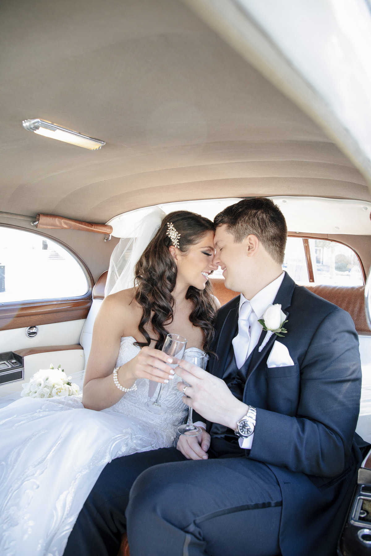 bride and groom in rolls royce after church ceremony