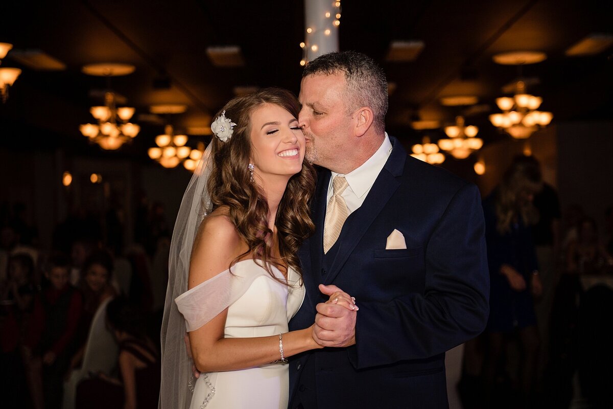 father daughter first dance at Parkersburg Art Center with chandelier lights in background