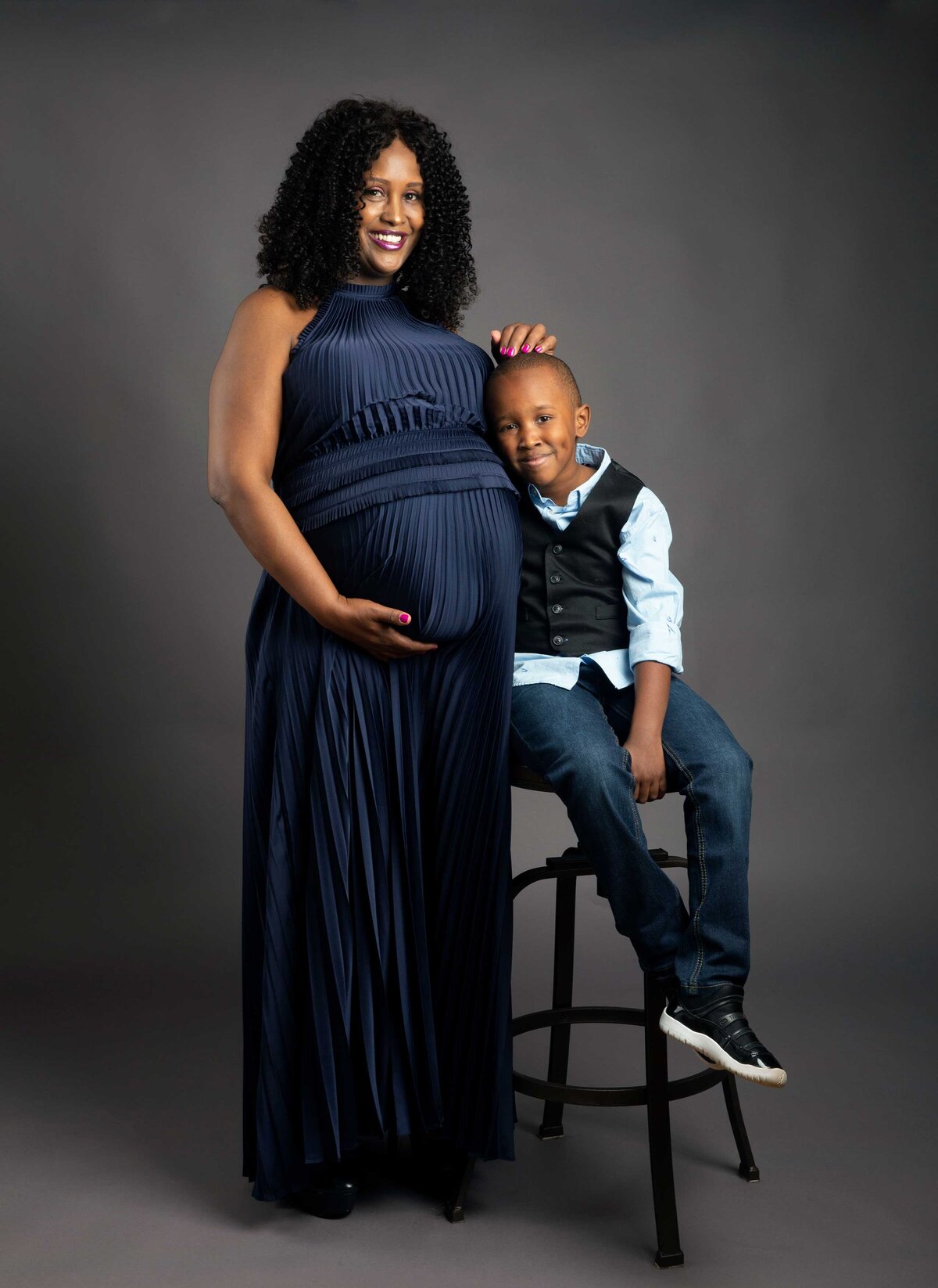 expecting mother studio portrait with her young son
