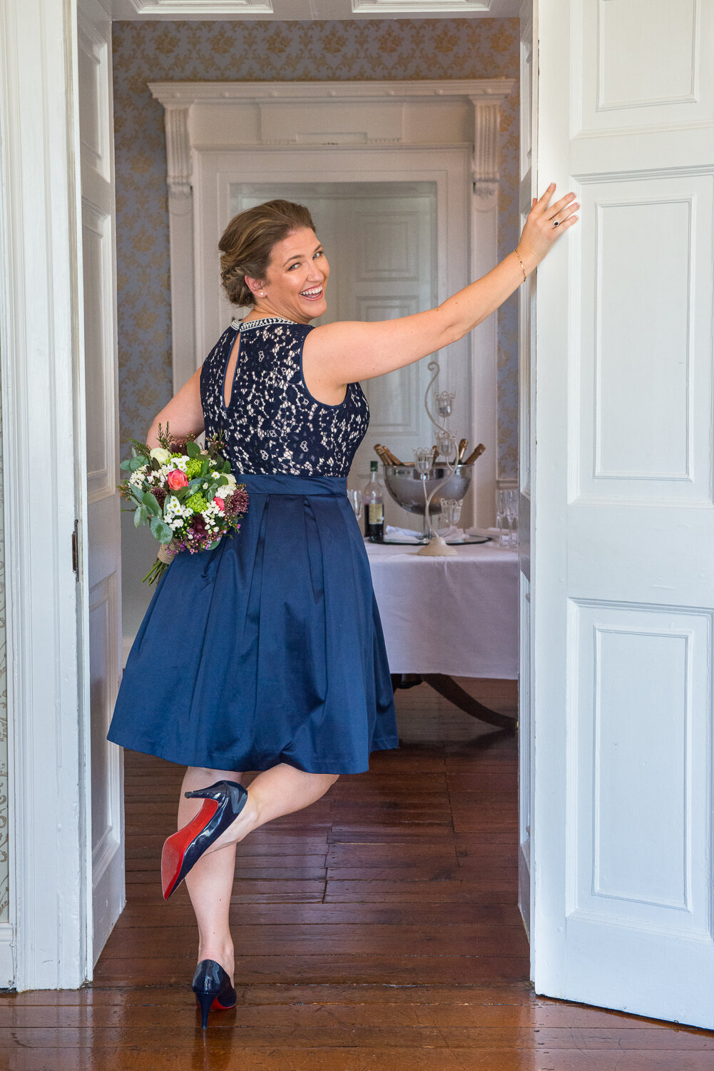 Bride in navy wedding dress wearing navy, red soled shoes