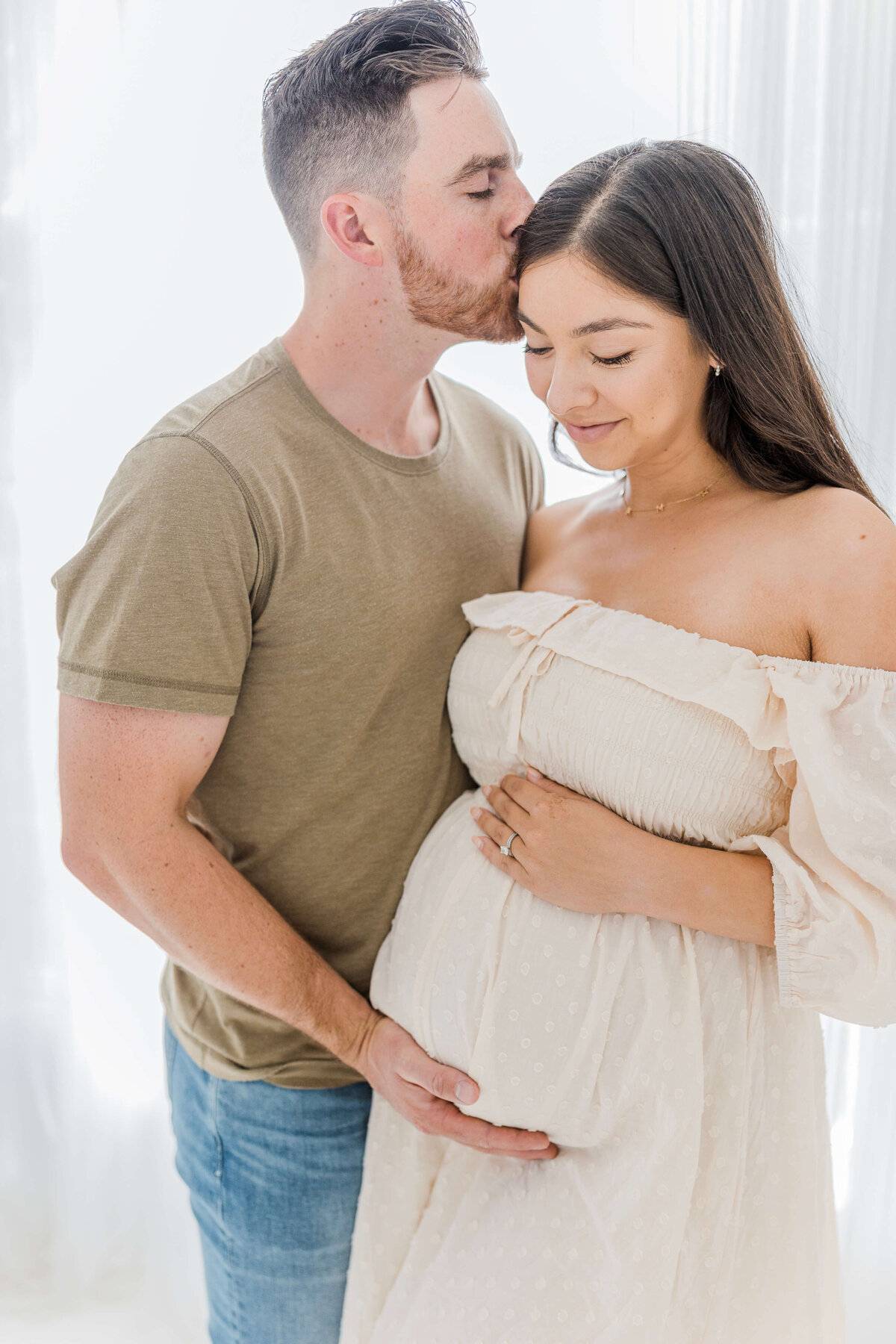 couple embracing pregnancy by Caroline Bendel, Folsom maternity photographer
