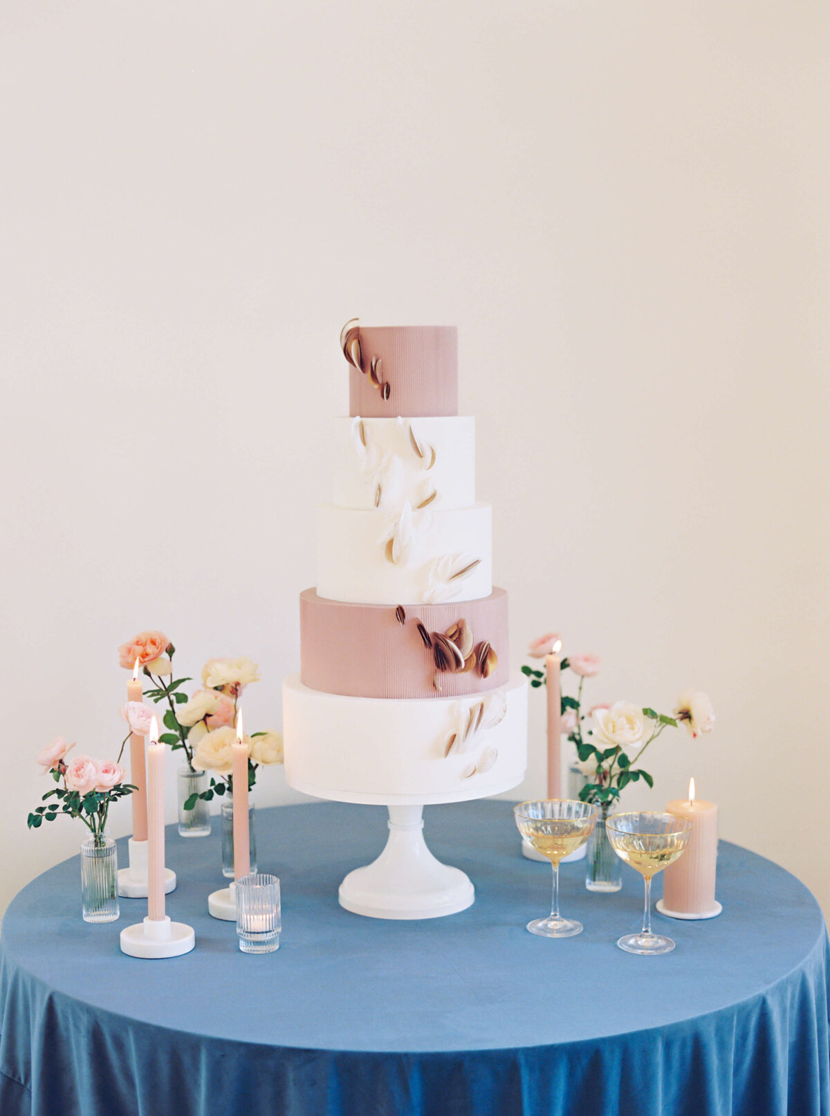 Five tier white and mauve wedding cake